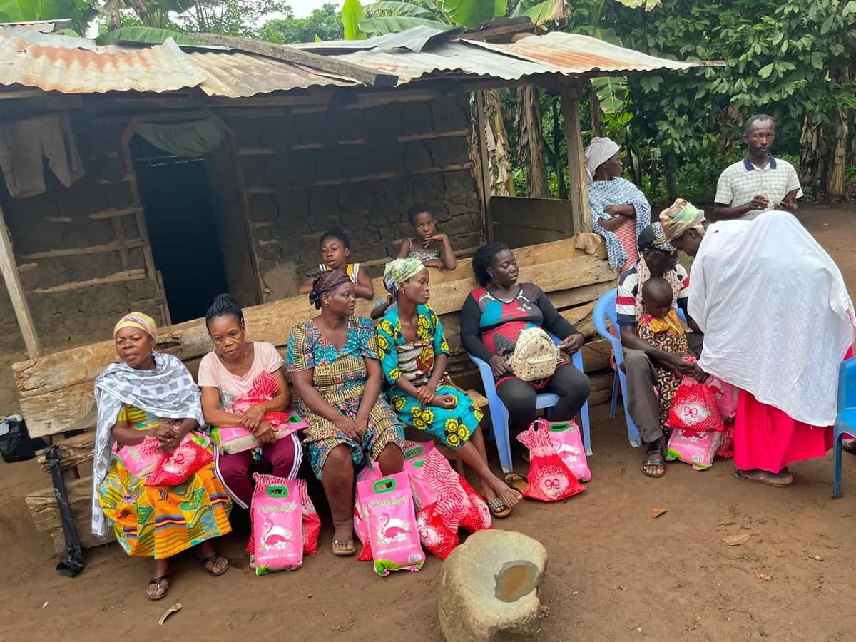 Women and families receiving bags of rice and provisions in a Ghanaian village
